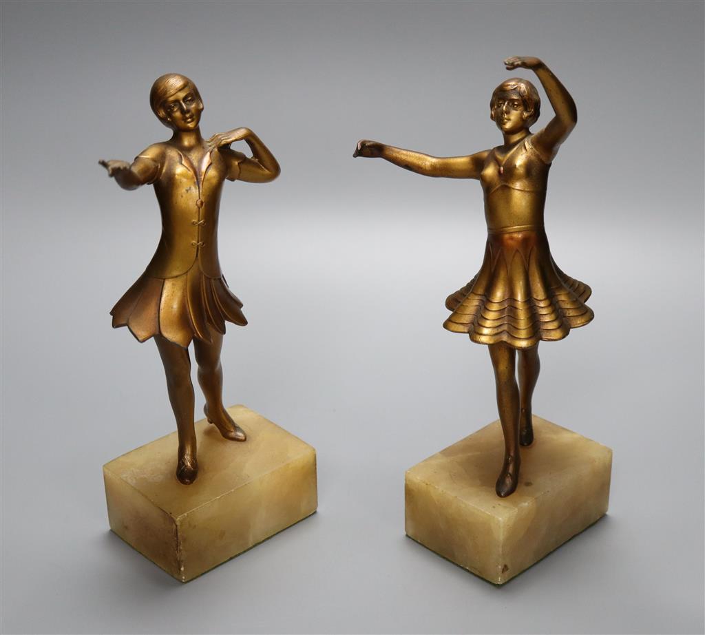 A pair of Art Deco gilt metal figures of young female dancers, on alabaster plinths, 25cm